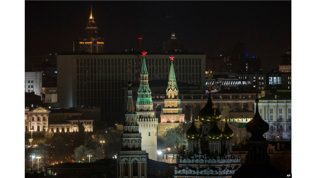 The Kremlin's towers and a church are illuminated before the lights were turned off to mark Earth Hour in Moscow, March 25, 2017.