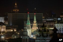 The Kremlin's towers and a church are illuminated before the lights were turned off to mark Earth Hour in Moscow, March 25, 2017.