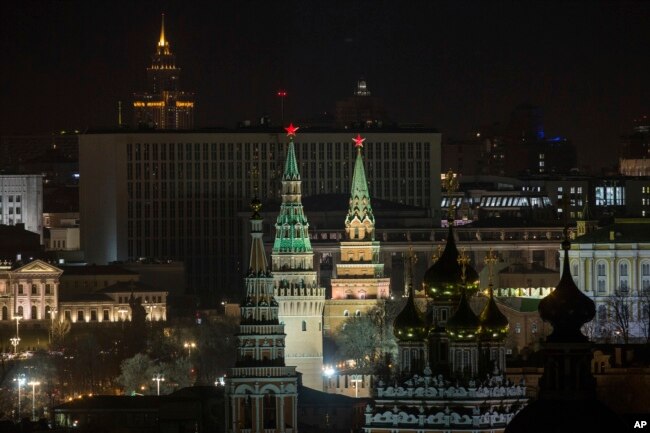 The Kremlin's towers and a church are illuminated before the lights were turned off to mark Earth Hour in Moscow, March 25, 2017.