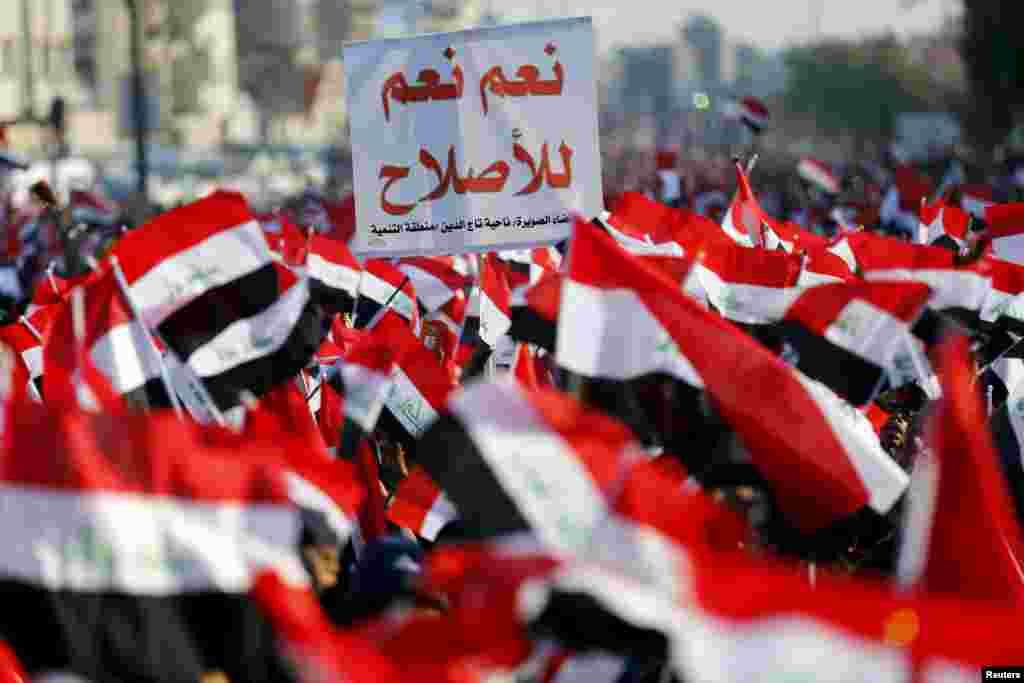 Supporters of prominent Iraqi Shi&#39;ite cleric Moqtada al-Sadr shout slogans during a protest against corruption at Tahrir Square in Baghdad.