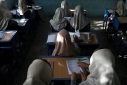 FILE - Afghan girls sit in a classroom at a school in Kabul, Afghanistan, September 18, 2021. (West Asia News Agency via Reuters)