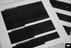 Special counsel Robert Mueller's report, with redactions, as released on Thursday, April 18, 2019, is photographed in Washington.