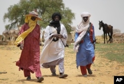 Peul and Tuareg herdsmen walk to the livestock market in the desert village of Sakabal, Niger, 220 kms (140 miles) north of Maradi, July 22, 2017.