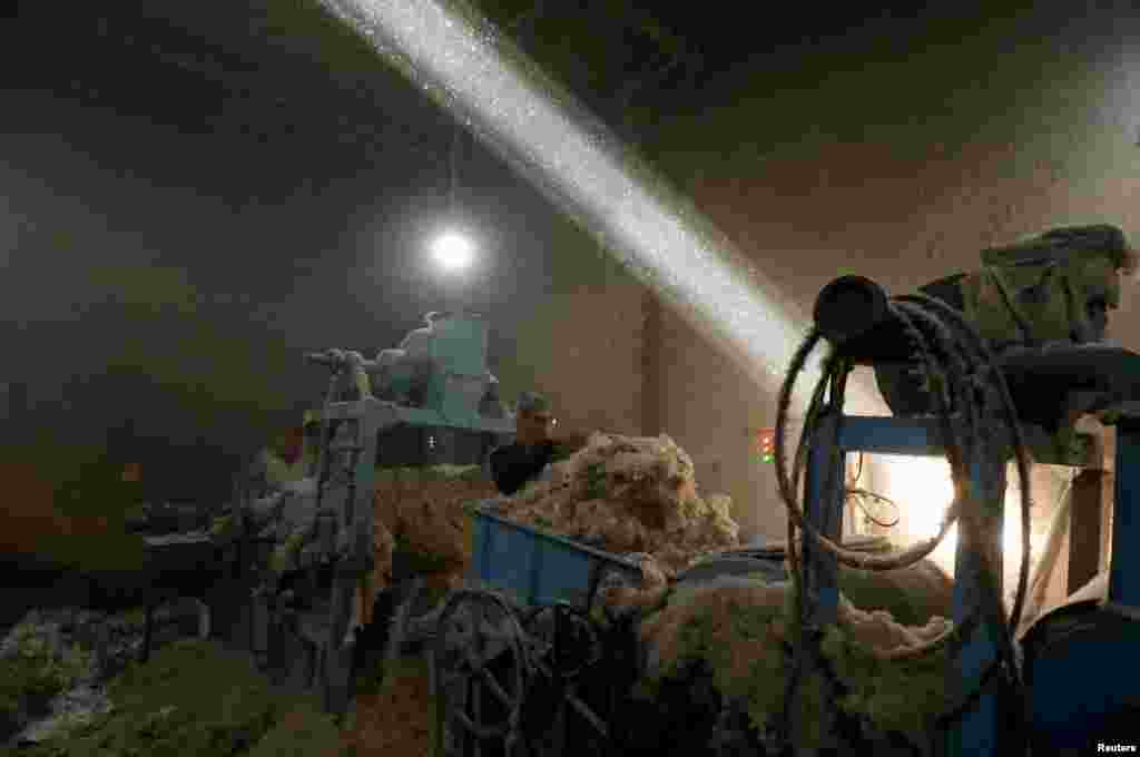 A laborer works at a cotton gin workshop in Peshawar, Pakistan.