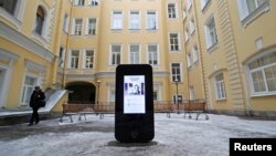 A man walks past a recently erected iPhone-shaped monument in memory of Apple's late co-founder Steve Jobs in the yard of the State University of Information Technologies, Mechanics and Optics, St. Petersburg, January 10, 2013.