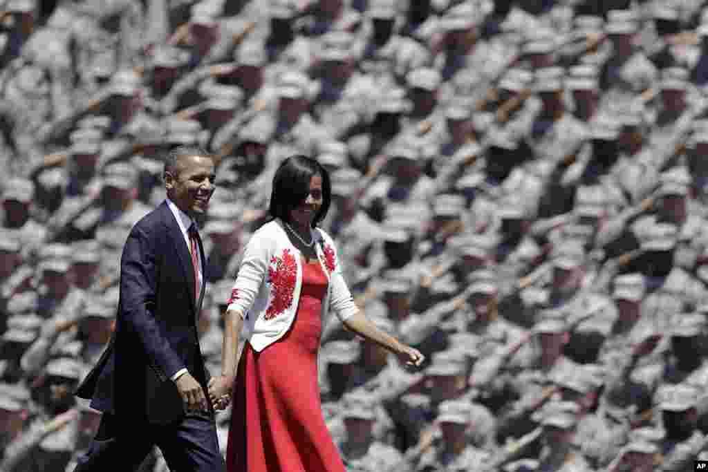 President Barack Obama and first lady Michelle are saluted by soldiers as they arrive at Fort Stewart in Georgia, April 27, 2012. (AP)