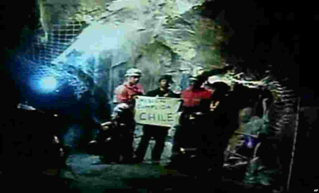 In this screen grab taken from video, rescuers inside the San Jose Mine near Copiapo, Chile, hold a sign that reads "Mission Complete" in Spanish after all 33 trapped miners were rescued Wednesday, Oct. 13, 2010. (AP Photo)