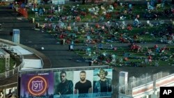 FILE - Personal belongings and debris litter the Route 91 Harvest festival grounds across the street from the Mandalay Bay resort and casino in Las Vegas, Oct. 3, 2017.