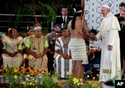 Pope Francis greets an indigenous representative in Puerto Maldonado, Peru, Jan. 19, 2018