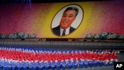 Dancers perform as a portrait of late North Korean leader Kim Il Sung is formed during "The Glorious Country" mass games at May Day Stadium in Pyongyang, North Korea, Oct. 25, 2018. North Korea has extended the run of the iconic mass games, which it revived last month to mark the country's 70th birthday.