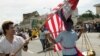 FILE PHOTO - Cambodian Student Society members Sraiph Phan, 21, left, and Danny Sre, 16, march during the Cambodian New Year's Parade in Long Beach Calif., on Sunday, April 24, 2005.