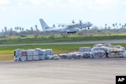 A World Food Program plane takes off from Beira International Airport after dropping off supplies for survivors of Cyclone Idai in Beira, Mozambique, March, 31, 2019.