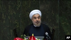 Iranian President Hassan Rouhani speaks during a debate in parliament on his proposed cabinet, in Tehran August 12, 2013.