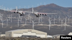 The world's largest airplane, built by the late Paul Allen's company Stratolaunch Systems, lands during its first test flight in Mojave, California, April 13, 2019. 