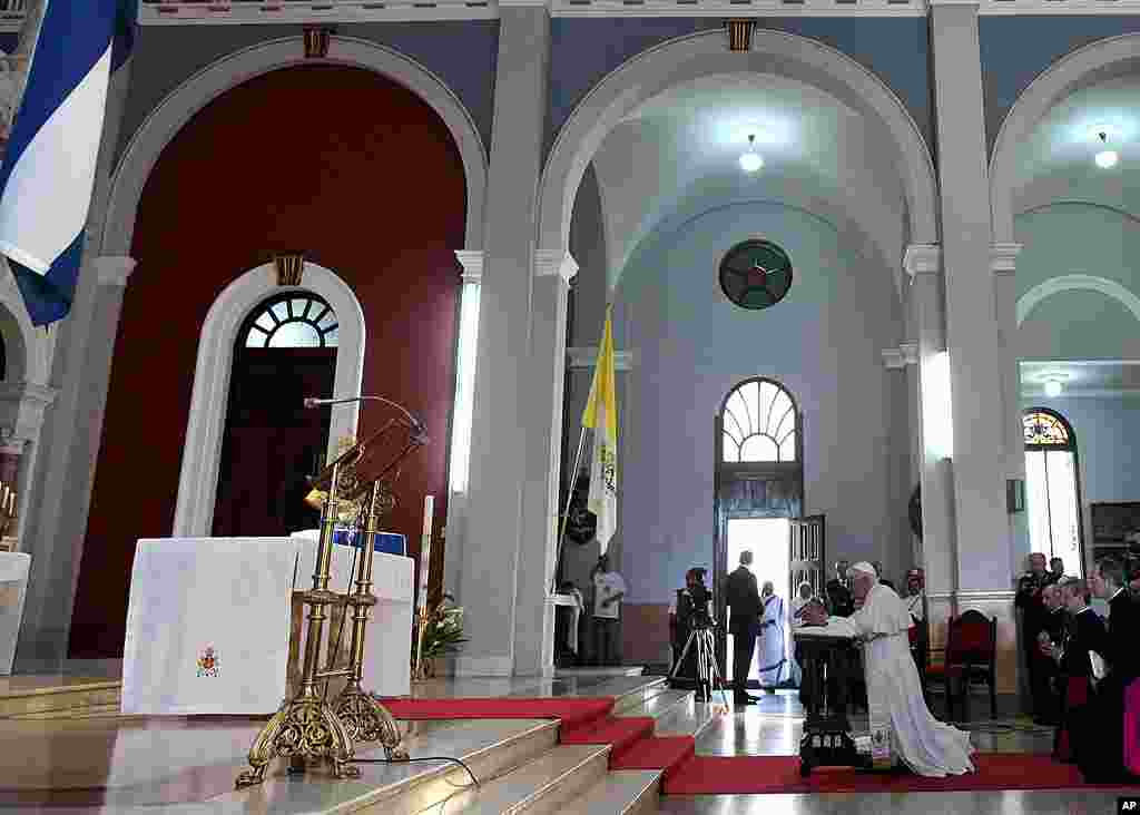 Pope Benedict kneels before the Virgin of Charity of Cobre, Cuba's patron saint, in Santiago de Cuba, Cuba, March 27, 2012. (AP)
