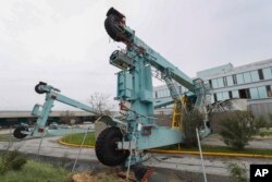 A crane used at the port to move cargo from ships lays on top of the Fusion Cuisine and Bar restaurant after the passing of Hurricane Maria in the La Guancha area of Ponce, Puerto Rico, Sept. 21, 2017.