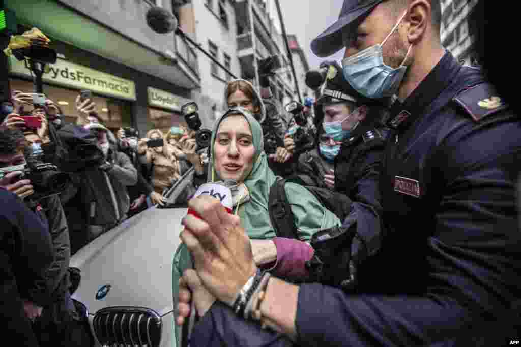 Silvia Romano, escorted by Carabinieri, arrives at her home, in Milan, Italy. The young Italian woman has returned to her homeland after 18 months as a hostage in eastern Africa.