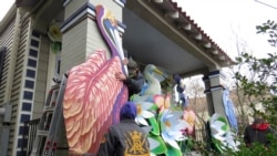 Travis Keene and Joey Mercer are two parade float workers. They are decorating a house in New Orleans, on Friday, Jan. 8, 2021. (AP Photo/Janet McConnaughey)