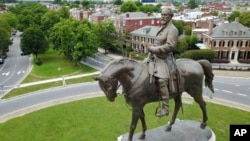 FILE - The statue of Confederate Gen. Robert E. Lee stands in the middle of a traffic circle on Monument Avenue in Richmond, Virginia.