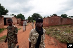 FILE - Seleka rebels walk through the town of Bria, Central African Republic, July 15, 2013. Recent fighting between rival militia groups in the Central African Republic has killed 16 people, U.N. peacekeepers said Wednesday, Nov. 23, 2016.