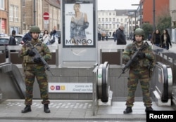 Belgian soldiers keep guard outside a metro station during tensions between police and residents, in the Brussels neighborhood of Molenbeek, April 2, 2016.