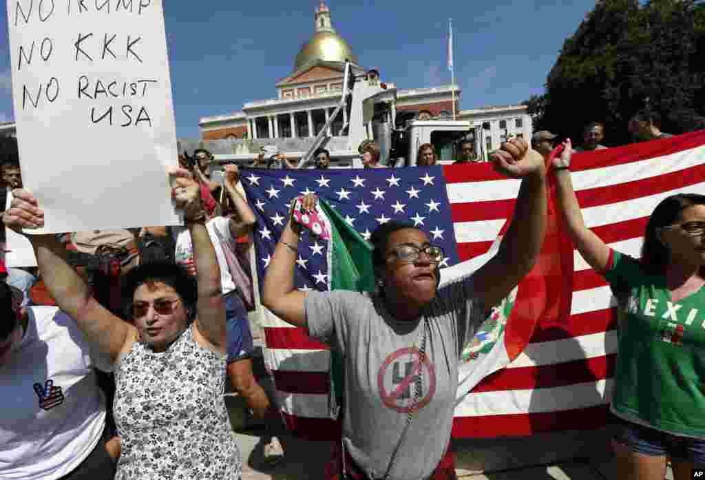 Counterprotesters hold signs and chant at the Statehouse before a planned "Free Speech" rally by conservative organizers begins on the adjacent Boston Common, Aug. 19, 2017, in Boston.