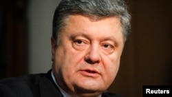 Petro Poroshenko, the billionaire owner of Ukrainian chocolate manufacture Roshen, and front-runner in Ukraine's presidential election, listens during an interview with Reuters in Kiev April 4, 2014