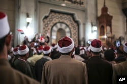 FILE - Muslim clerics are seen gathered at a mosque in central Cairo, Egypt, Feb. 3, 2015. Muslim clerics and scholars not in line with Islamic State postulates have been the latest target of IS propaganda videos.
