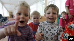 FILE - Kids look on in the Republican Hospital for Infectious Diseases, which specializes in treating HIV-positive children in Ust-Izhora outside St. Petersburg, Russia, Tuesday, May 30, 2006.