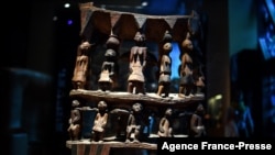 FILE - A royal seat of the 'Royal treasures of Abomey kingdom' (Œuvres des tresors royaux d'Abomey) on display at the Musee du quai Branly in Paris, Sept. 10, 2021.