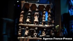 FILE - A royal seat of the 'Royal treasures of Abomey kingdom' (Œuvres des tresors royaux d'Abomey) on display at the Musee du quai Branly in Paris, Sept. 10, 2021.