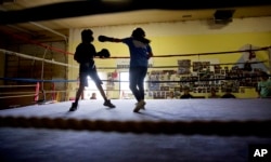 Beatrice Kipp, 13, right, spars with Timmy Sellars, 14, at the Blackfeet Native Boxing Club on the Blackfeet Indian Reservation in Browning, Mont., July 14, 2018. "I'm protective of our children because of human trafficking," said Frank Kipp who teaches his daughters how to box and runs the club. "We teach our girls if someone grabs you, you fight to your death."