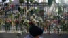 A memorial for the victims of an apartment building fire is displayed in front of the building in New York, Friday, Jan. 14, 2022.