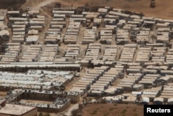 FILE - A general view shows tents of Syrian refugees on the outskirts of the Lebanese town of Arsal, near the border with Syria, Lebanon, Sept. 21, 2016.