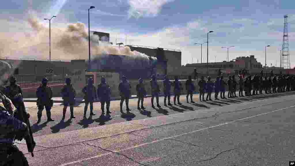 Iraqi security forces stand guard in front of the U.S. embassy in Baghdad, Iraq.