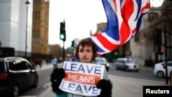 A pro-Brexit protester stands outside the Houses of Parliament in London, Britain, Feb. 7, 2019.
