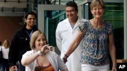 Erika Brannock, 29, a Baltimore area pre-school teacher who lost a leg in the Boston Marathon bombings, is accompanied by her mother, Carol Downing (R) as she is released from Beth Israel Deaconess Medical Center in Boston, June 3, 2013. 