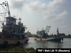 A fishing boat pulls into a port in Samut Sakhon, Thailand, March 25, 2018.