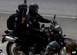 Members of the Venezuelan Bolivarian Intelligence Service arrive to the Junquito highway during an operation to capture Oscar Perez, according to officials, in Caracas, Jan. 15, 2018.