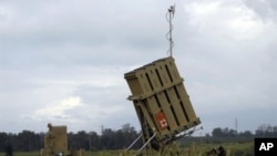 Israeli soldiers stand next to an "Iron Dome" short-range missile defence system after it was deployed near the costal city of Ashkelon on April 4, 2011