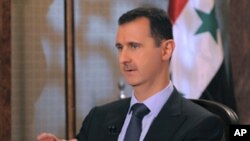 Syria's President Bashar al-Assad speaks during an interview with Syrian state television, Damascus, August 21, 2011.