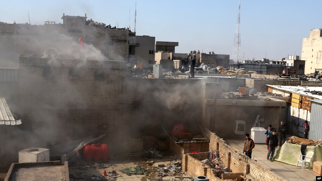 Warga sipil memeriksa lokasi serangan bom mobil di pusat perbelanjaan di Lapangan Khilani di Baghdad tengah, 5 Februari 2014. 
