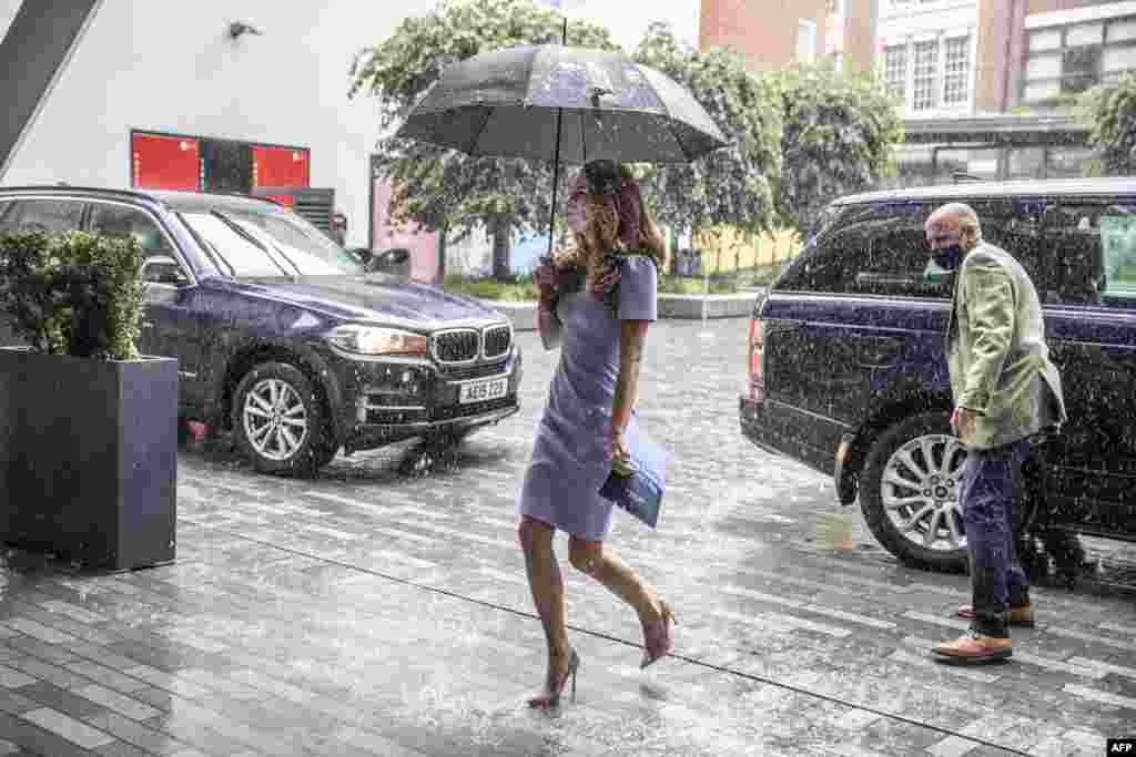 Britain&#39;s Catherine, Duchess of Cambridge, shelters from the rain under an umbrella as she arrives at the London School of Economics to mark the launch of The Royal Foundation Centre for Early Childhood, in London.