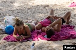 Russian tourists enjoy the beach in Phuket
