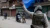 FILE - Indian paramilitary soldiers order commuters to turn back during a security lockdown in downtown Srinagar, Indian-controlled Kashmir, March 1, 2019.
