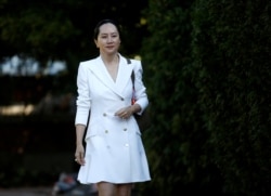 FILE - Huawei Technologies Chief Financial Officer Meng Wanzhou leaves her home to appear for a hearing in Vancouver, British Columbia, Canada, Sept. 30, 2019.