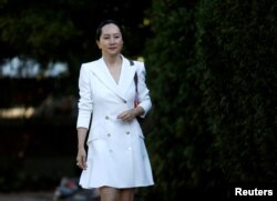 FILE - Huawei Technologies Chief Financial Officer Meng Wanzhou leaves her home to appear for a hearing in Vancouver, British Columbia, Sept. 30, 2019.