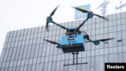 FILE - A drone is seen during a demonstration for the media before a news conference by a Chinese food delivery company on its drone delivery service, in Shanghai, China, May 29, 2018. 