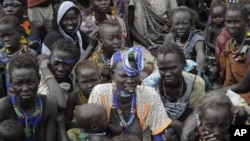 Victims of ethnic violence in Jonglei, state, South Sudan, wait in line at the World Food Program distribution center in Pibor, South Sudan to receive emergency food rations, Thursday, Jan.12, 2012.