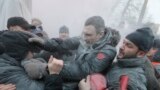 Opposition leader and former WBC heavyweight boxing champion Vitali Klitschko, center, is attacked and sprayed with a fire extinguisher as he tries to stop the clashes between police and protesters in central Kyiv, Ukraine.&nbsp;